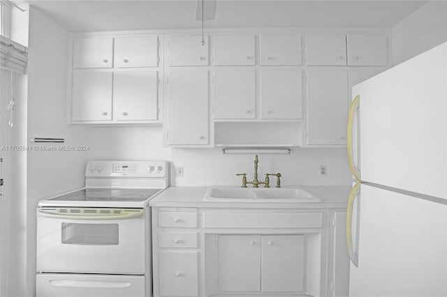 kitchen with white cabinets, white appliances, and sink