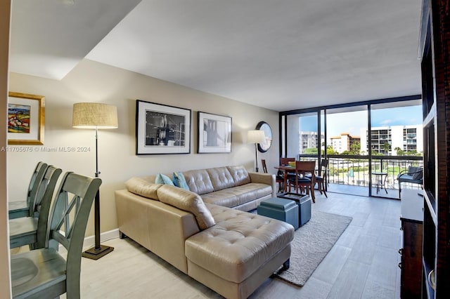 living room with floor to ceiling windows and light hardwood / wood-style flooring