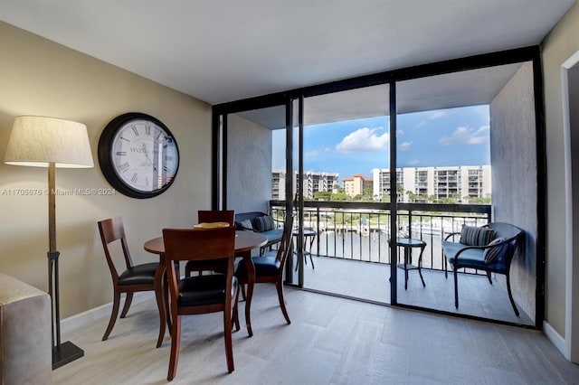 dining area featuring light hardwood / wood-style flooring and expansive windows