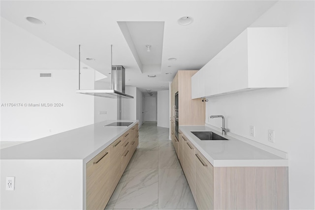 kitchen with light brown cabinets, black electric cooktop, and sink