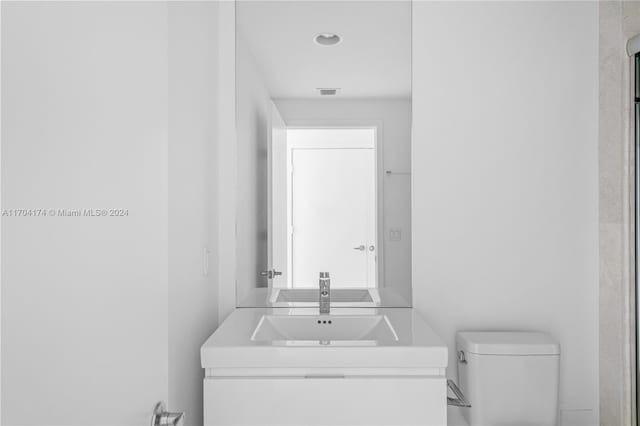 bathroom with vanity and toilet