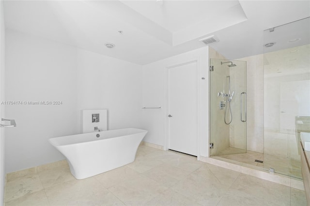 bathroom featuring shower with separate bathtub