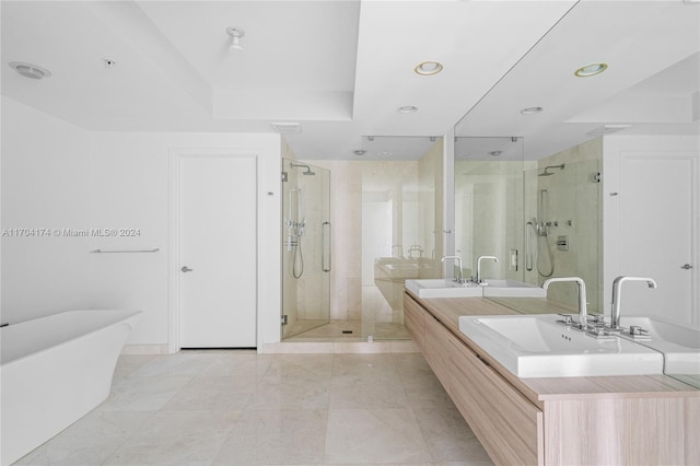 bathroom with vanity and separate shower and tub