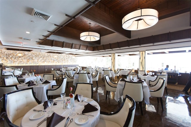 dining area featuring beam ceiling, wooden ceiling, and a wealth of natural light