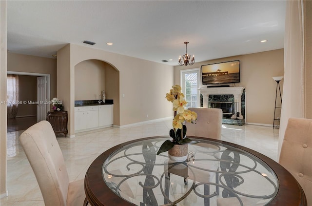 dining area featuring marble finish floor, visible vents, a fireplace, and baseboards