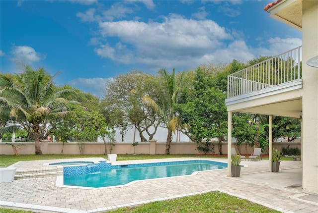 view of pool featuring a fenced in pool, fence, a patio, and an in ground hot tub