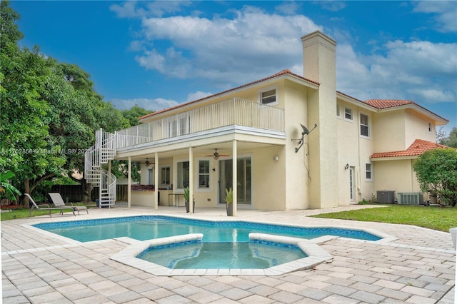 back of house with a ceiling fan, a balcony, stairs, central air condition unit, and stucco siding