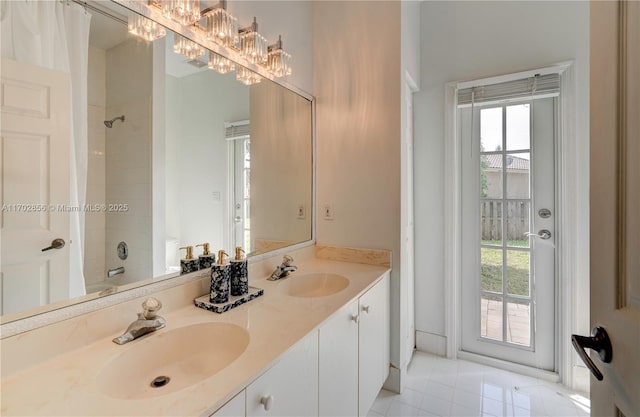 bathroom with  shower combination, a wealth of natural light, and a sink