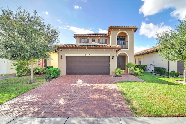 mediterranean / spanish-style house with a garage and a front yard