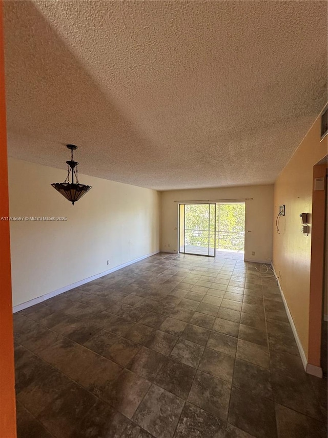 unfurnished room with a textured ceiling