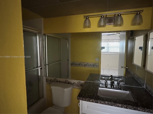 bathroom with shower / bath combination with glass door and vanity