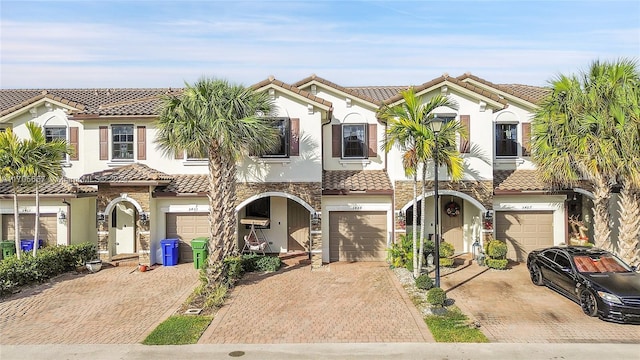 mediterranean / spanish home featuring a garage