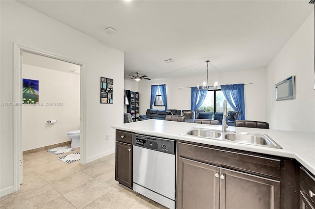 kitchen featuring sink, stainless steel dishwasher, decorative light fixtures, light tile patterned flooring, and dark brown cabinetry