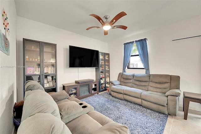 living room with ceiling fan and light tile patterned floors