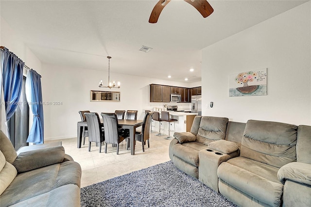 living room featuring ceiling fan with notable chandelier and light tile patterned floors