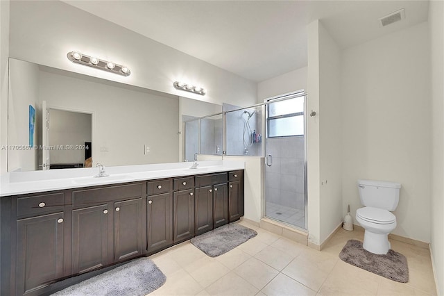 bathroom featuring tile patterned floors, vanity, an enclosed shower, and toilet