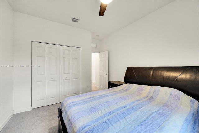 bedroom with ceiling fan, a closet, and light colored carpet