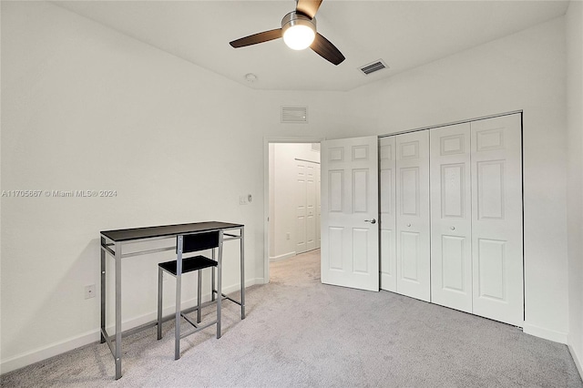 carpeted bedroom featuring ceiling fan and a closet