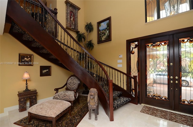 foyer with french doors and a high ceiling