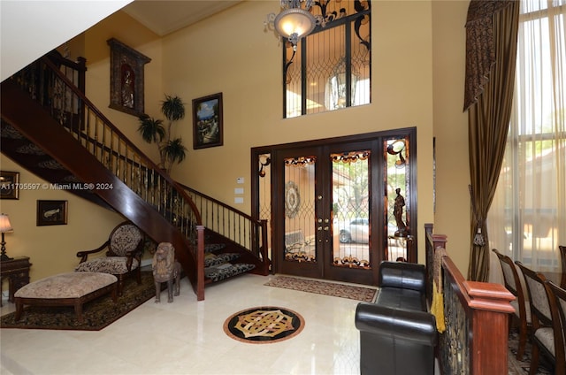 entrance foyer featuring french doors and a towering ceiling