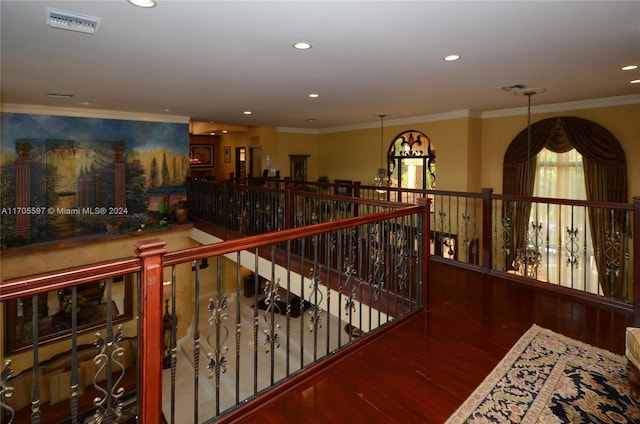 corridor featuring dark wood-type flooring and ornamental molding