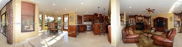 living room with ceiling fan and ornamental molding