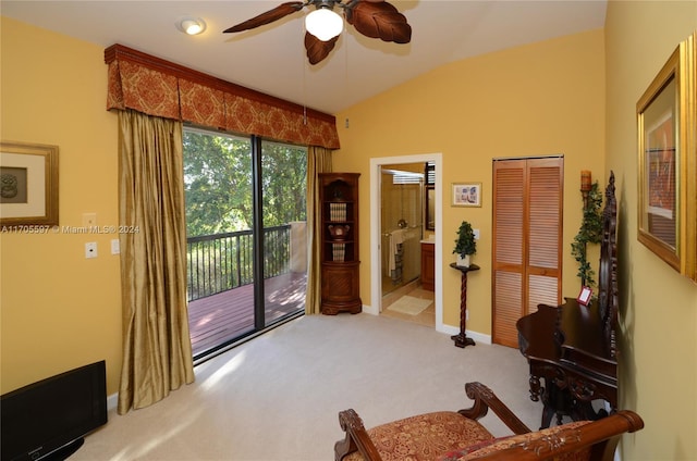 living area featuring light colored carpet, ceiling fan, and lofted ceiling