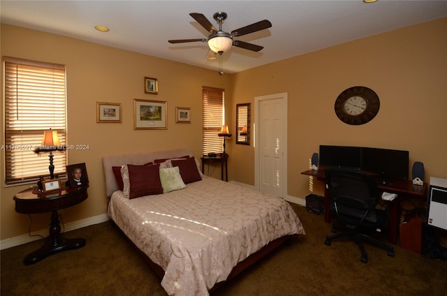 bedroom with ceiling fan and dark colored carpet