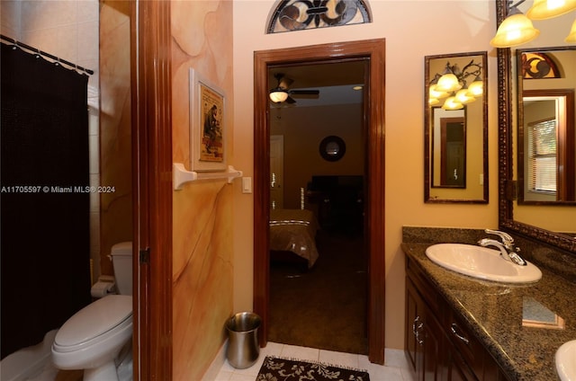 bathroom with tile patterned flooring, vanity, toilet, and ceiling fan