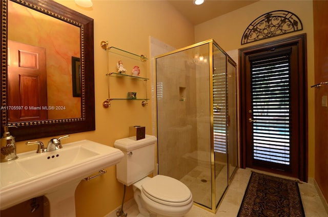 bathroom featuring sink, tile patterned flooring, a shower with shower door, and toilet