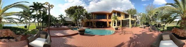 view of pool with a jacuzzi and a patio area