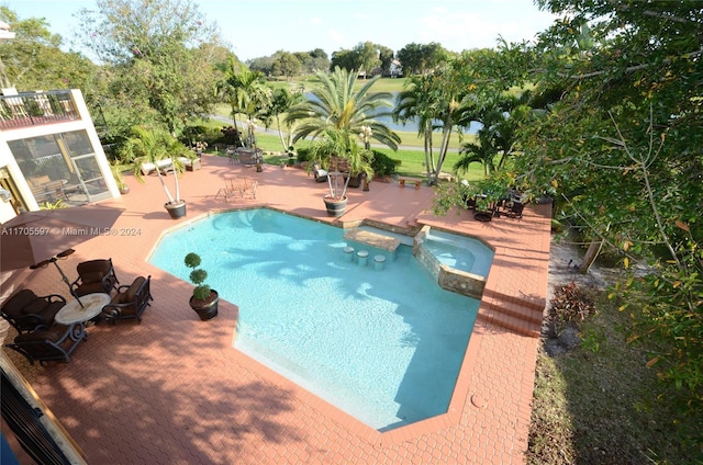 view of swimming pool featuring an in ground hot tub and a patio