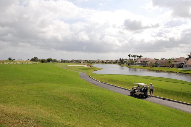 view of community featuring a yard and a water view