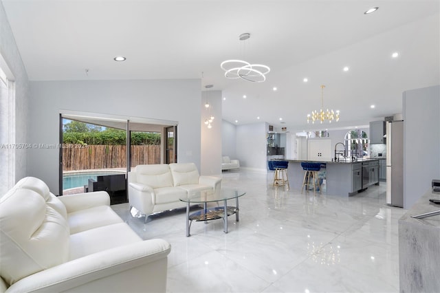 living room with sink, vaulted ceiling, and a notable chandelier