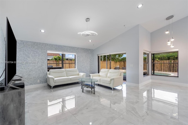 living room featuring high vaulted ceiling