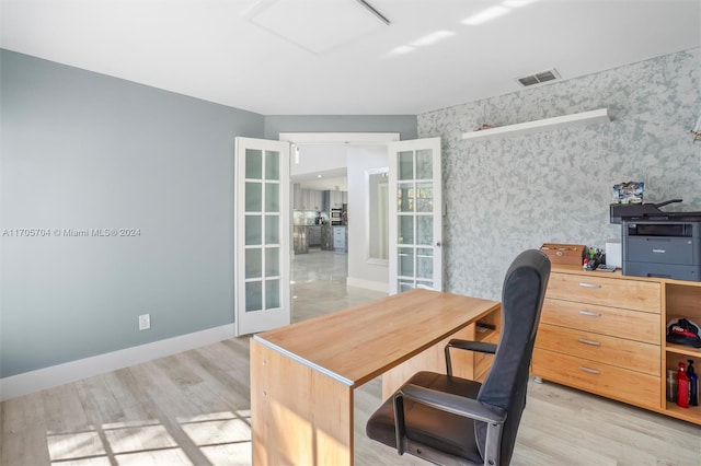 office space with french doors and light hardwood / wood-style floors