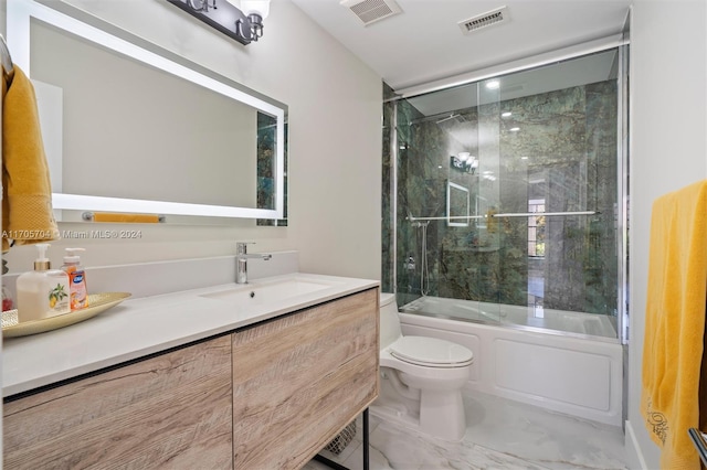 full bathroom featuring toilet, vanity, and combined bath / shower with glass door