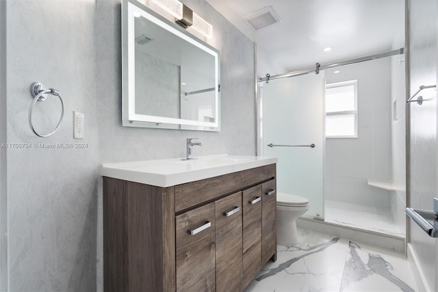 bathroom featuring vanity, toilet, and a shower with shower door