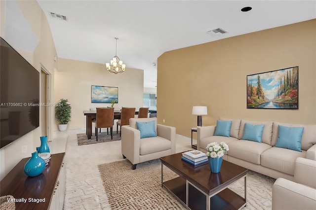 living room featuring light carpet and a chandelier