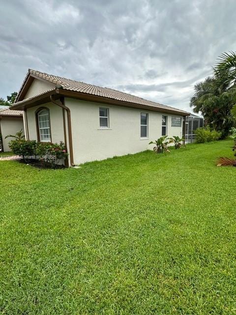 rear view of property featuring a yard