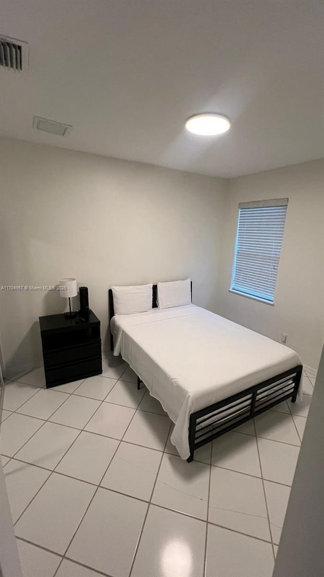 bedroom featuring light tile patterned flooring