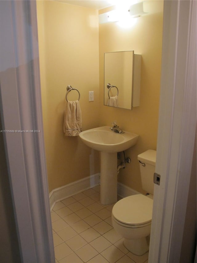 bathroom with sink, tile patterned flooring, and toilet