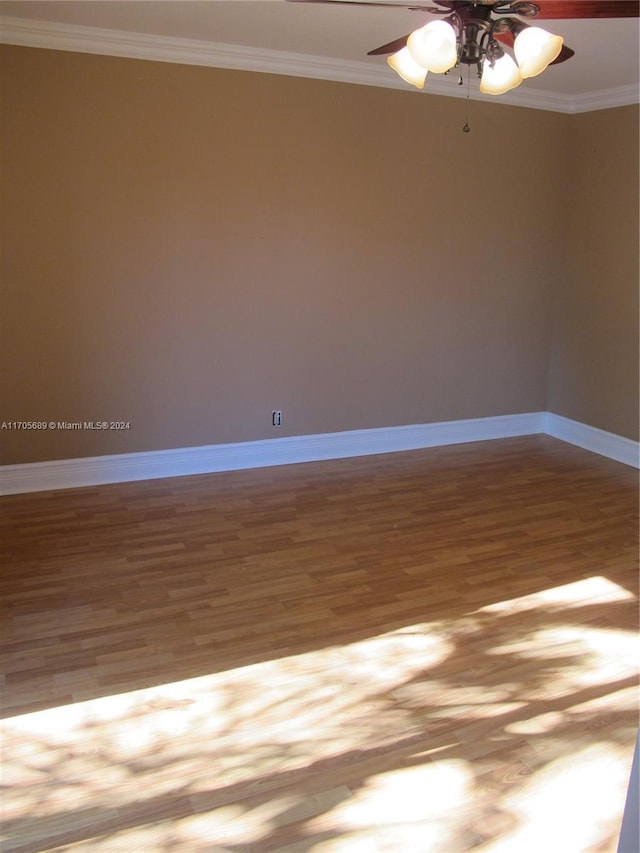 empty room featuring hardwood / wood-style flooring, ceiling fan, and crown molding