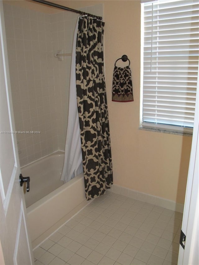 bathroom with tile patterned floors and shower / bath combination with curtain