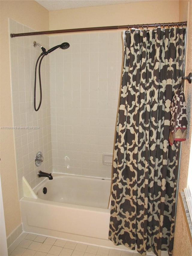 bathroom featuring tile patterned floors and shower / bath combo with shower curtain