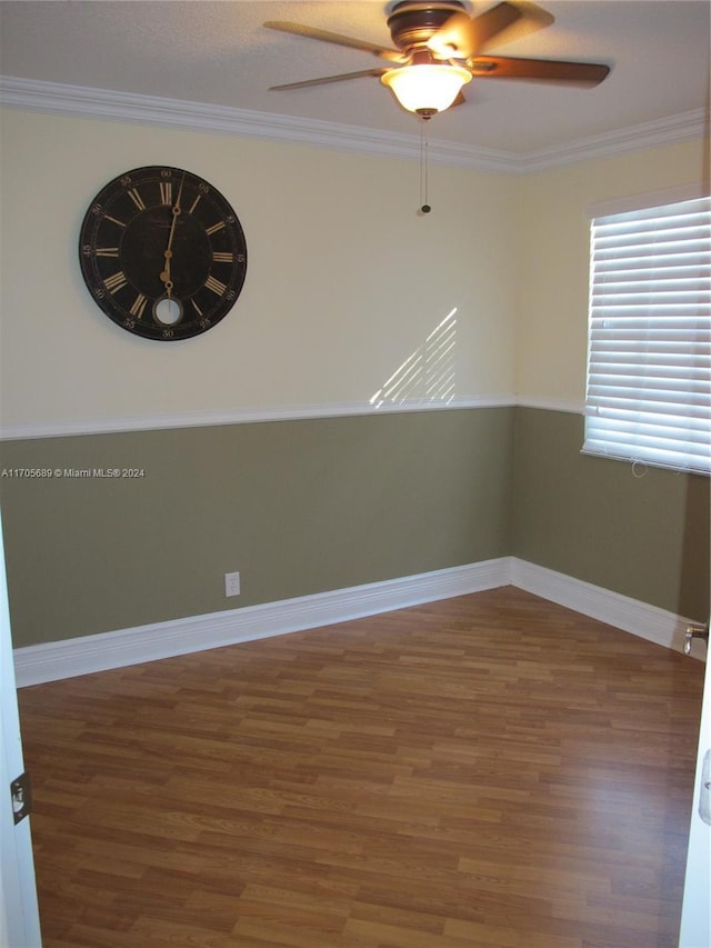 unfurnished room featuring dark hardwood / wood-style flooring, ceiling fan, and ornamental molding