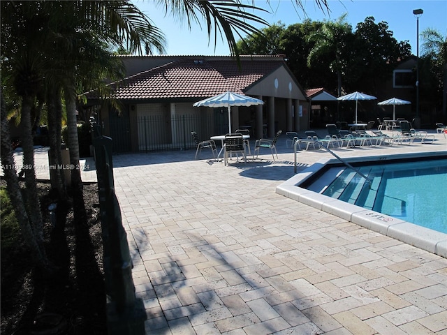 view of swimming pool featuring a patio area