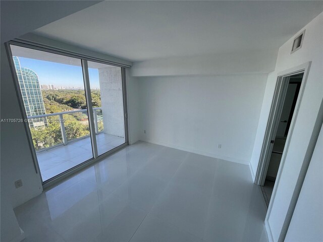 spare room with floor to ceiling windows