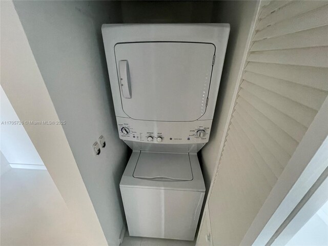 laundry room with stacked washer / drying machine