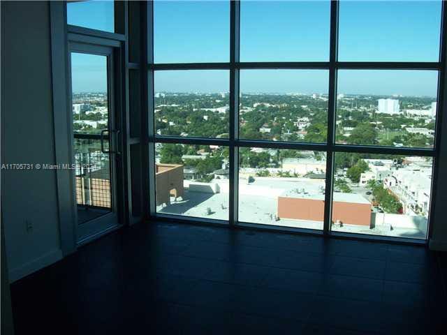 doorway to outside featuring floor to ceiling windows